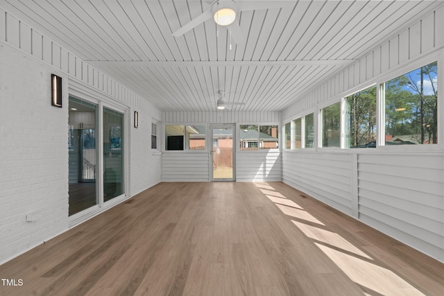 unfurnished sunroom with a ceiling fan