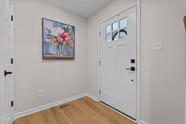 entrance foyer with light wood-style floors, visible vents, and baseboards