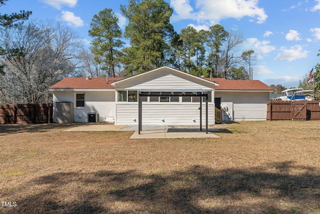 rear view of property with a yard, a patio area, fence, and cooling unit