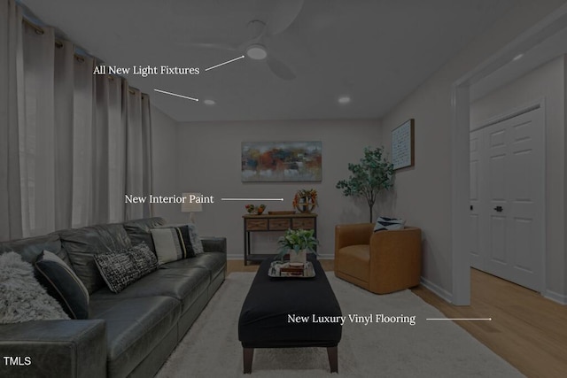 living area with baseboards, wood finished floors, and a ceiling fan