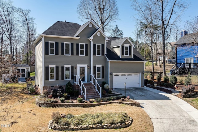 colonial-style house featuring concrete driveway, a garage, and a shingled roof