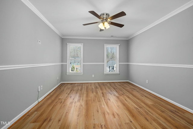 empty room featuring light wood-type flooring, baseboards, ceiling fan, and crown molding