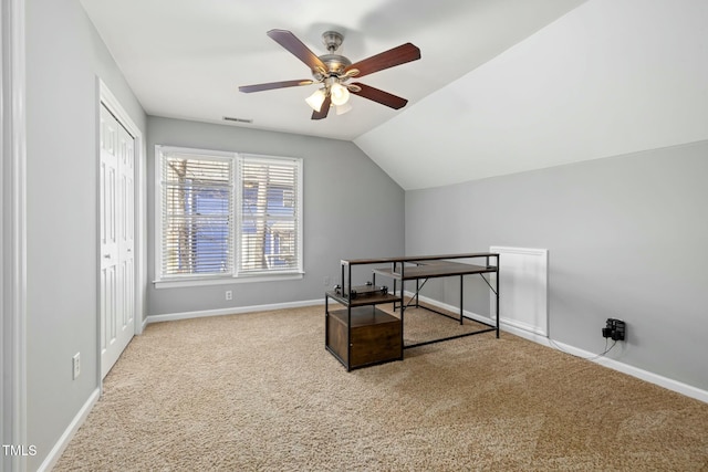 interior space with visible vents, ceiling fan, baseboards, lofted ceiling, and a closet