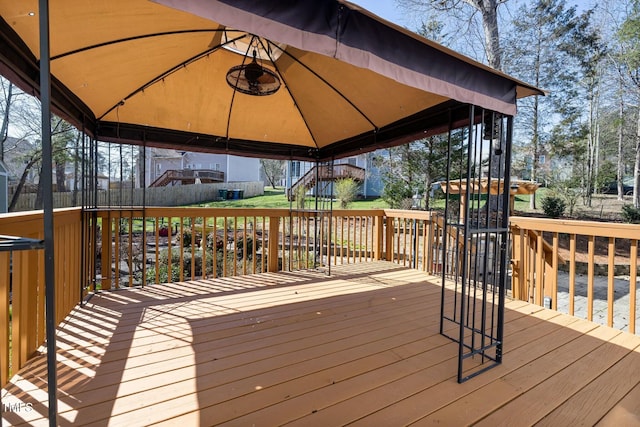 wooden terrace featuring a gazebo