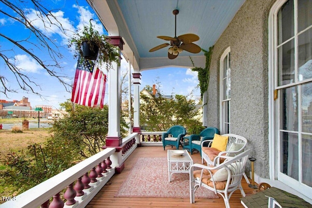 balcony with a porch and a ceiling fan