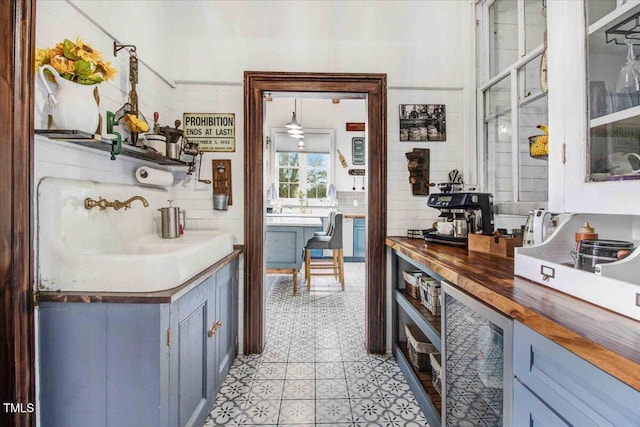 kitchen featuring wine cooler, backsplash, wooden counters, and a ceiling fan