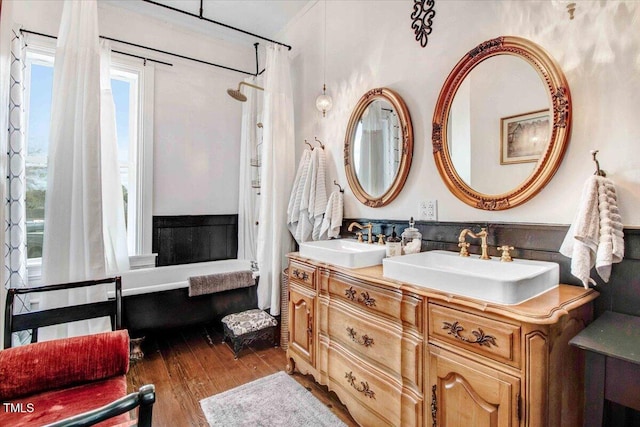 full bathroom featuring double vanity, hardwood / wood-style flooring, a shower with curtain, and a sink