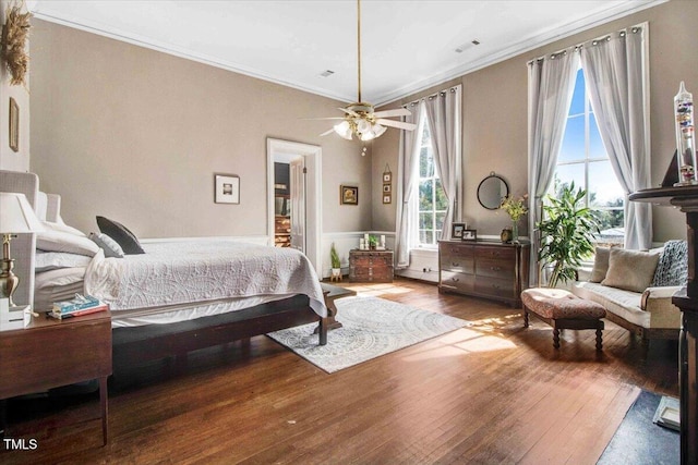 bedroom featuring visible vents, ornamental molding, and hardwood / wood-style flooring