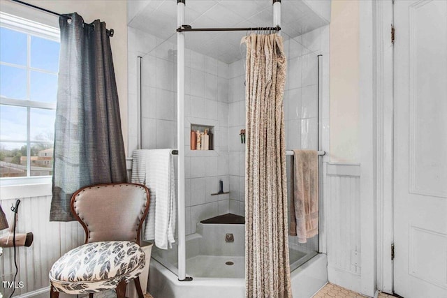 bathroom featuring bath / shower combo with glass door