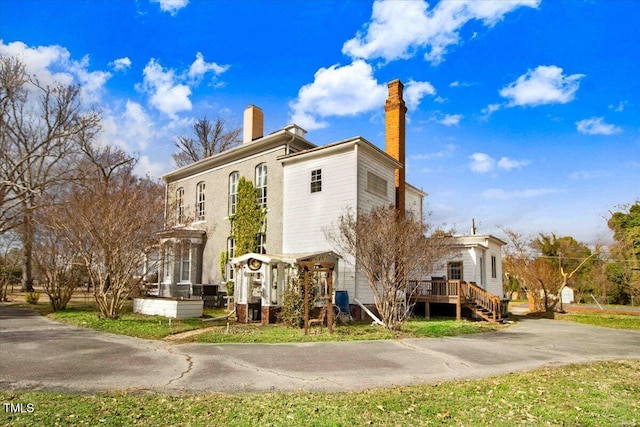 exterior space with a deck and a chimney