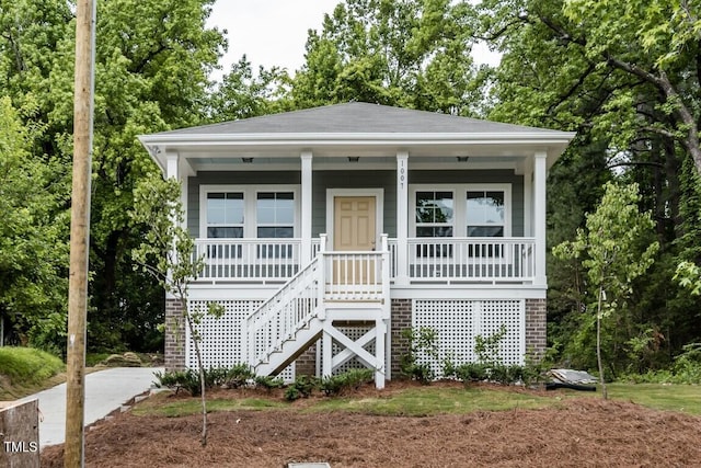 view of front of home with stairway and a porch