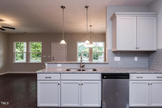 kitchen with tasteful backsplash, dark wood-type flooring, dishwasher, white cabinetry, and a sink