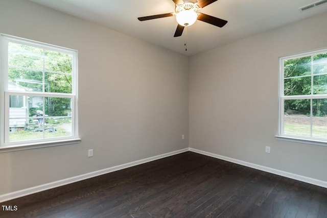 empty room with visible vents, ceiling fan, baseboards, and dark wood-style flooring