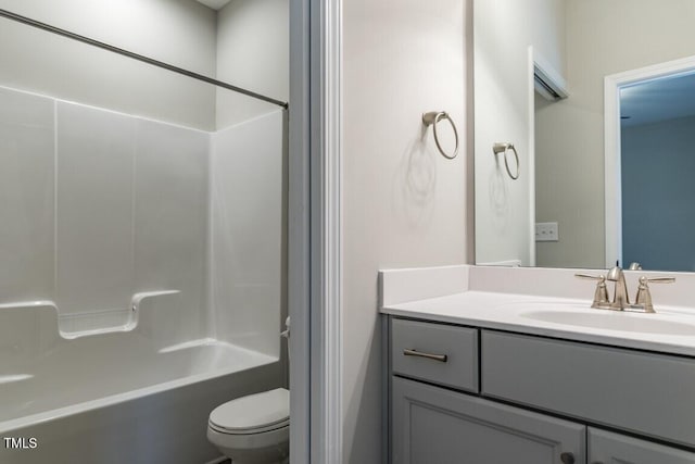 full bath featuring toilet, vanity, and shower / tub combination