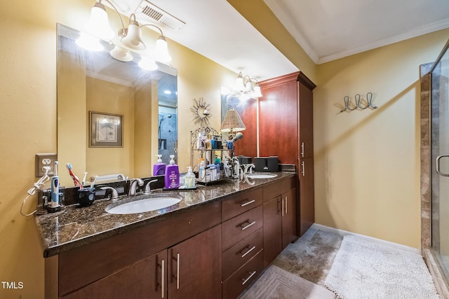 bathroom with visible vents, ornamental molding, a stall shower, and a sink