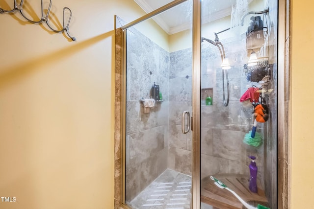 bathroom with a shower stall and crown molding