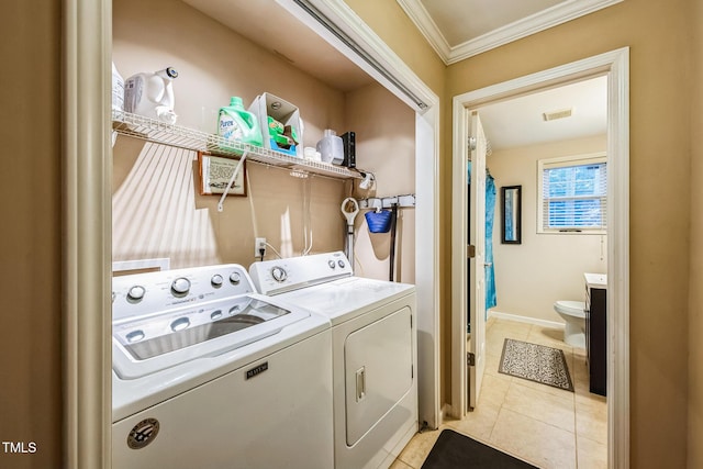 laundry area with visible vents, light tile patterned flooring, crown molding, laundry area, and washing machine and clothes dryer