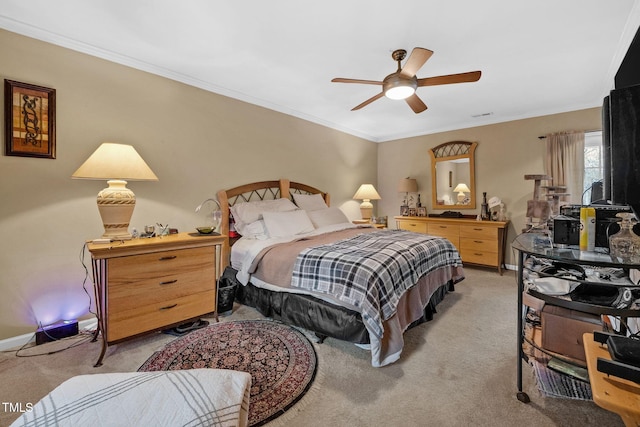 bedroom featuring light colored carpet, crown molding, baseboards, and ceiling fan