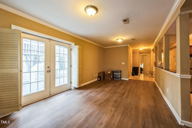 interior space with wood finished floors, visible vents, baseboards, ornamental molding, and french doors