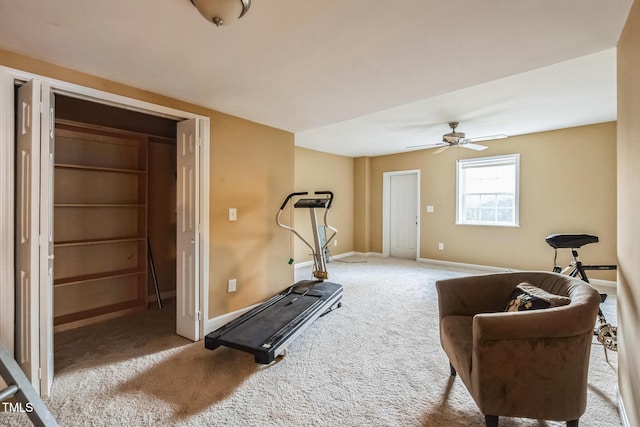 exercise area with baseboards, carpet floors, and ceiling fan