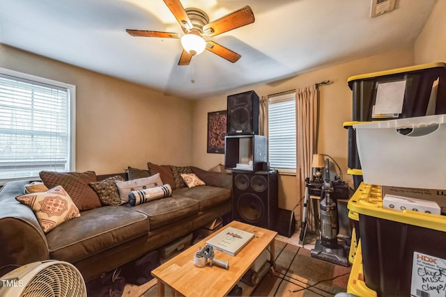 living room featuring visible vents and a ceiling fan