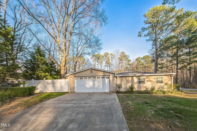 view of front of home with a garage, a front lawn, and fence