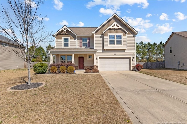 craftsman inspired home with a front lawn, driveway, fence, board and batten siding, and a garage