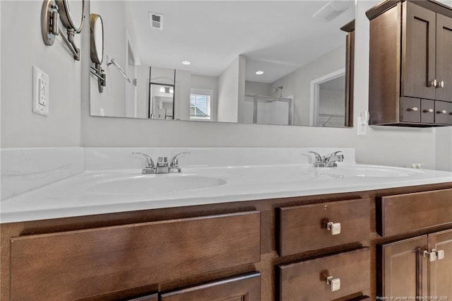 full bathroom featuring a sink, visible vents, and double vanity