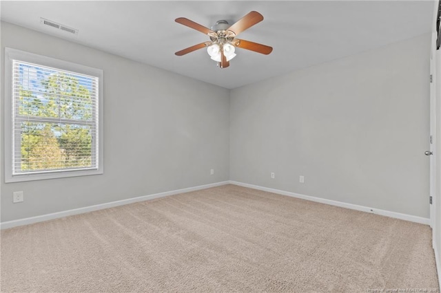 unfurnished room with baseboards, visible vents, carpet floors, and ceiling fan