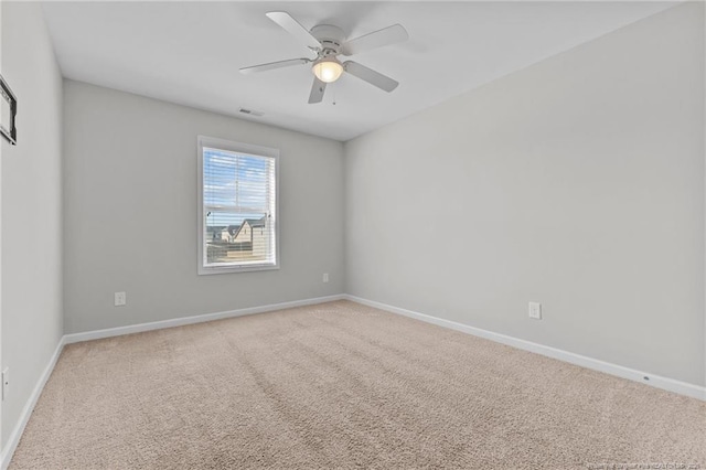 spare room featuring visible vents, baseboards, carpet, and ceiling fan