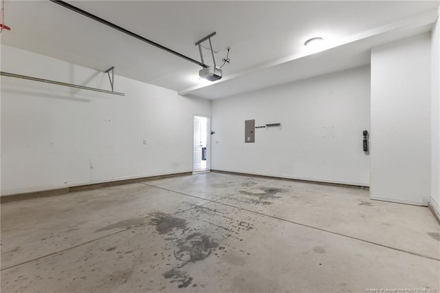 garage with electric panel, baseboards, and a garage door opener