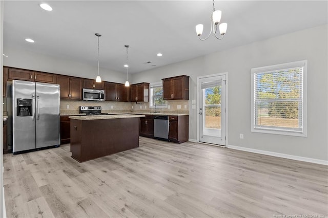 kitchen featuring decorative backsplash, light countertops, dark brown cabinets, and appliances with stainless steel finishes