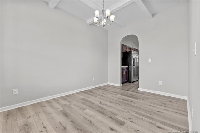 empty room with wood finished floors, baseboards, arched walkways, beamed ceiling, and a notable chandelier