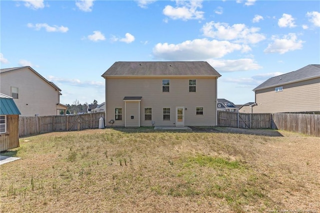 rear view of property with a patio area, a lawn, and a fenced backyard