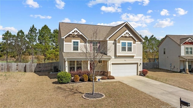 craftsman-style house featuring board and batten siding, concrete driveway, and fence