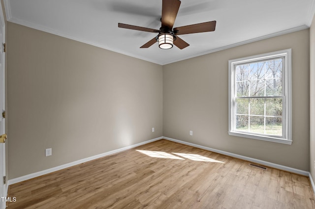 empty room with baseboards, light wood-style floors, visible vents, and ceiling fan