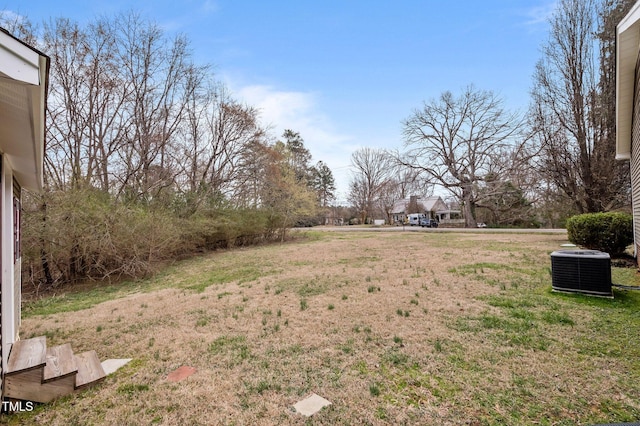 view of yard featuring central air condition unit