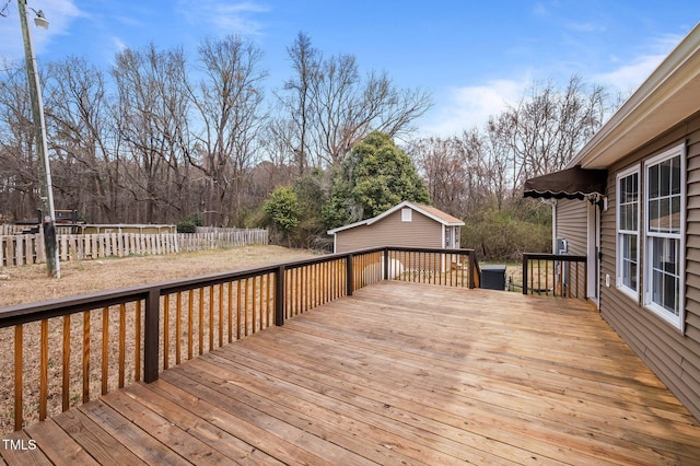 deck featuring an outbuilding and fence