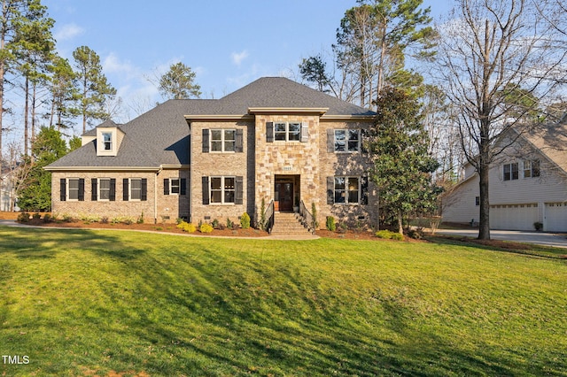 view of front of house featuring a front lawn, brick siding, and a shingled roof