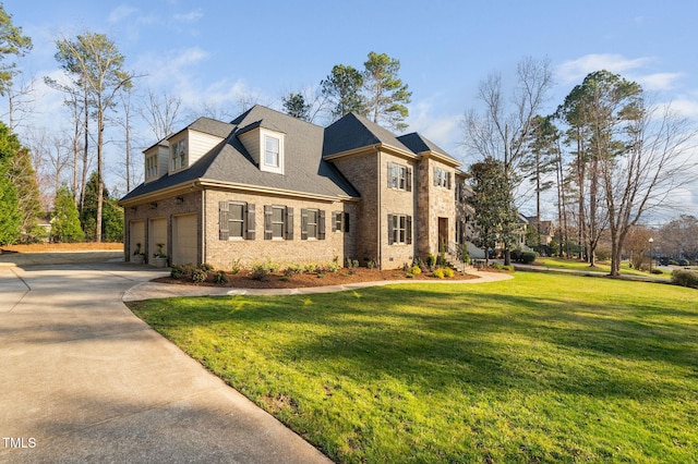 view of front of house featuring brick siding, a front lawn, concrete driveway, and a garage