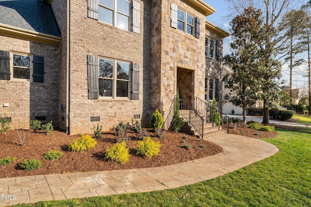 exterior space featuring crawl space and a front lawn