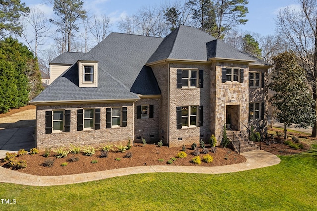 view of front of house featuring crawl space, a shingled roof, a front lawn, and brick siding