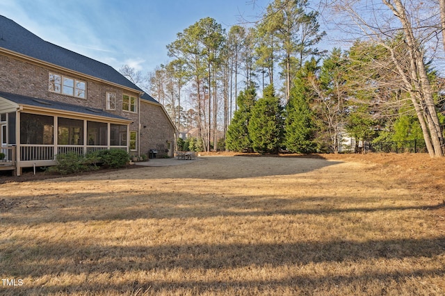 view of yard featuring a patio area and a sunroom