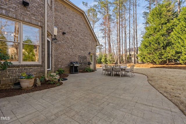 view of patio with area for grilling and outdoor dining area