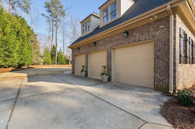 view of property exterior featuring a garage, driveway, and roof with shingles