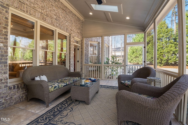 sunroom featuring vaulted ceiling with skylight