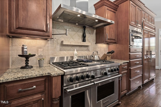 kitchen with dark wood finished floors, light stone countertops, stainless steel appliances, and exhaust hood