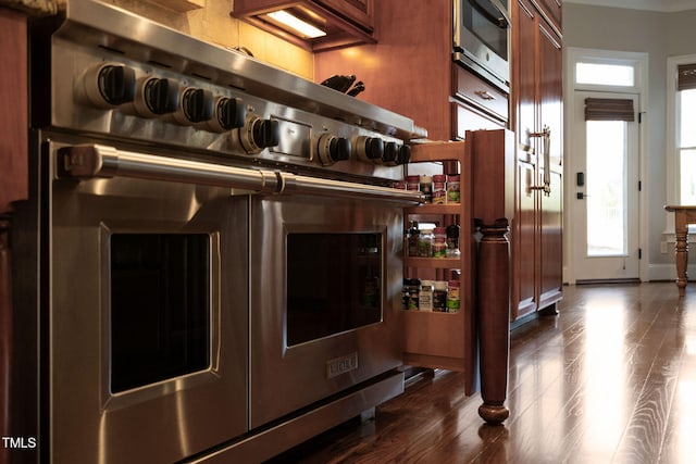 interior details featuring double oven range and dark wood finished floors