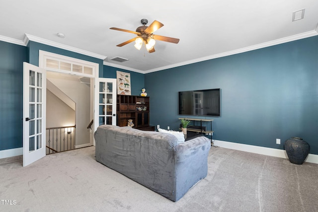 carpeted living room featuring visible vents, baseboards, crown molding, and ceiling fan