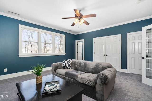 carpeted living area featuring visible vents, baseboards, ornamental molding, and a ceiling fan